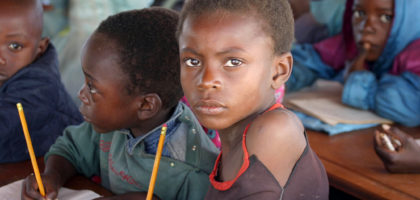 Zambian children attend school in a poverty stricken area near the country's capital Lusaka July 1, 2005. July 1 was designated "Whit Band Day" as campaigners began a week of action aimed at focusing attention on issues of poverty ahead of next weeks meeting of G8 leaders in Gleneagles, Scotland. REUTERS/Salim Henry  SH/AH - RP6DRMVDHNAB